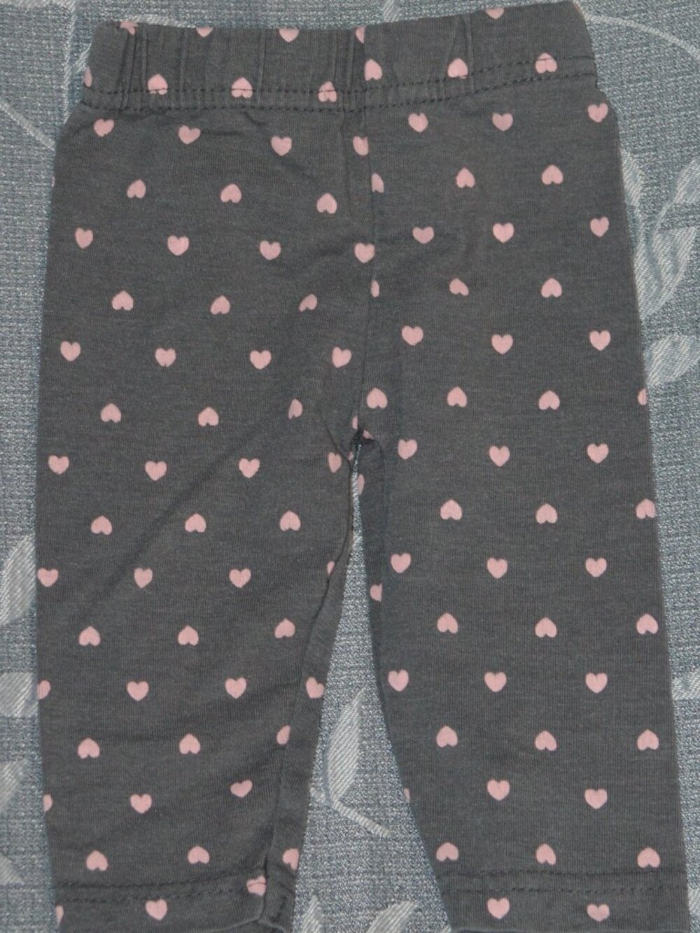 Baby leggings size 6–9 months. Dark gray color with pink heart print.